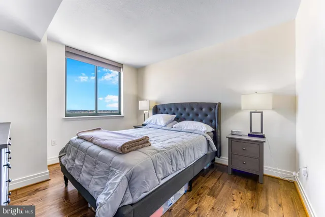 a bedroom with a bed and wooden floor