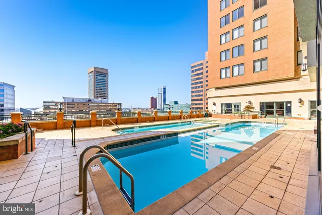 a swimming pool with outdoor seating and yard