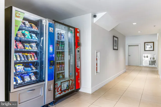 a view of an entryway with a lots of frames on wall