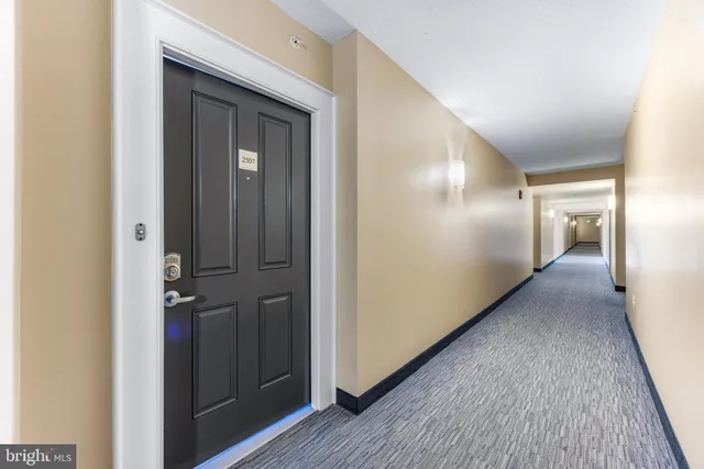 a view of hallway with wooden floor