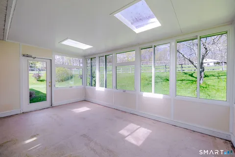a view of room with window and front door