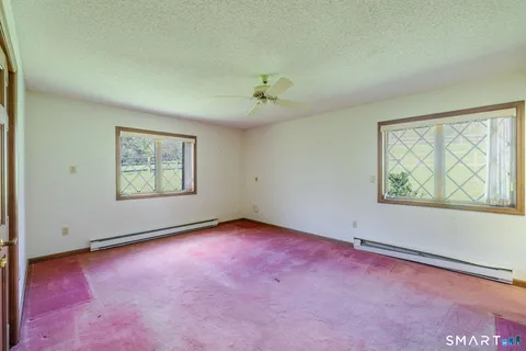 an empty room with windows and closet