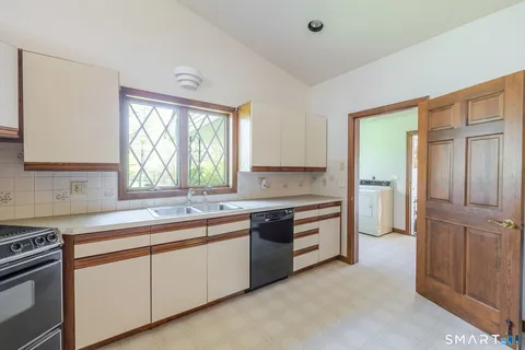 a kitchen with a sink stove and cabinets