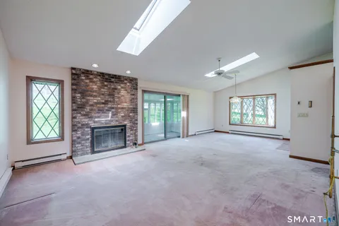 a view of empty room with a fireplace