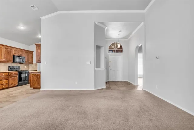 a view of a livingroom with kitchen and sink