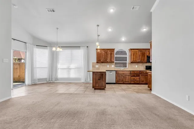 a large kitchen with a sink and cabinets