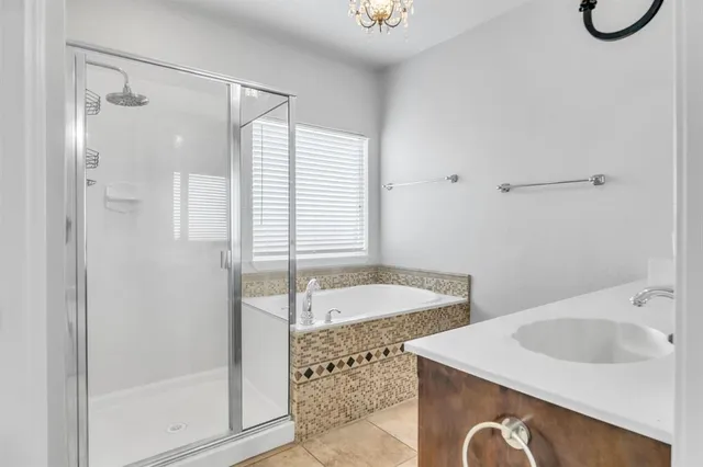 a bathroom with a tub sink and mirror