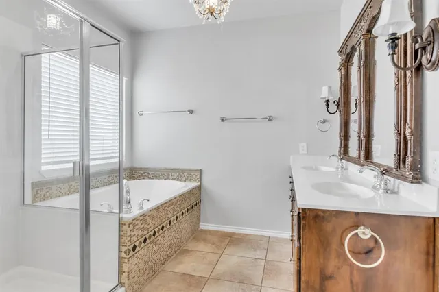a bathroom with a tub sink and mirror