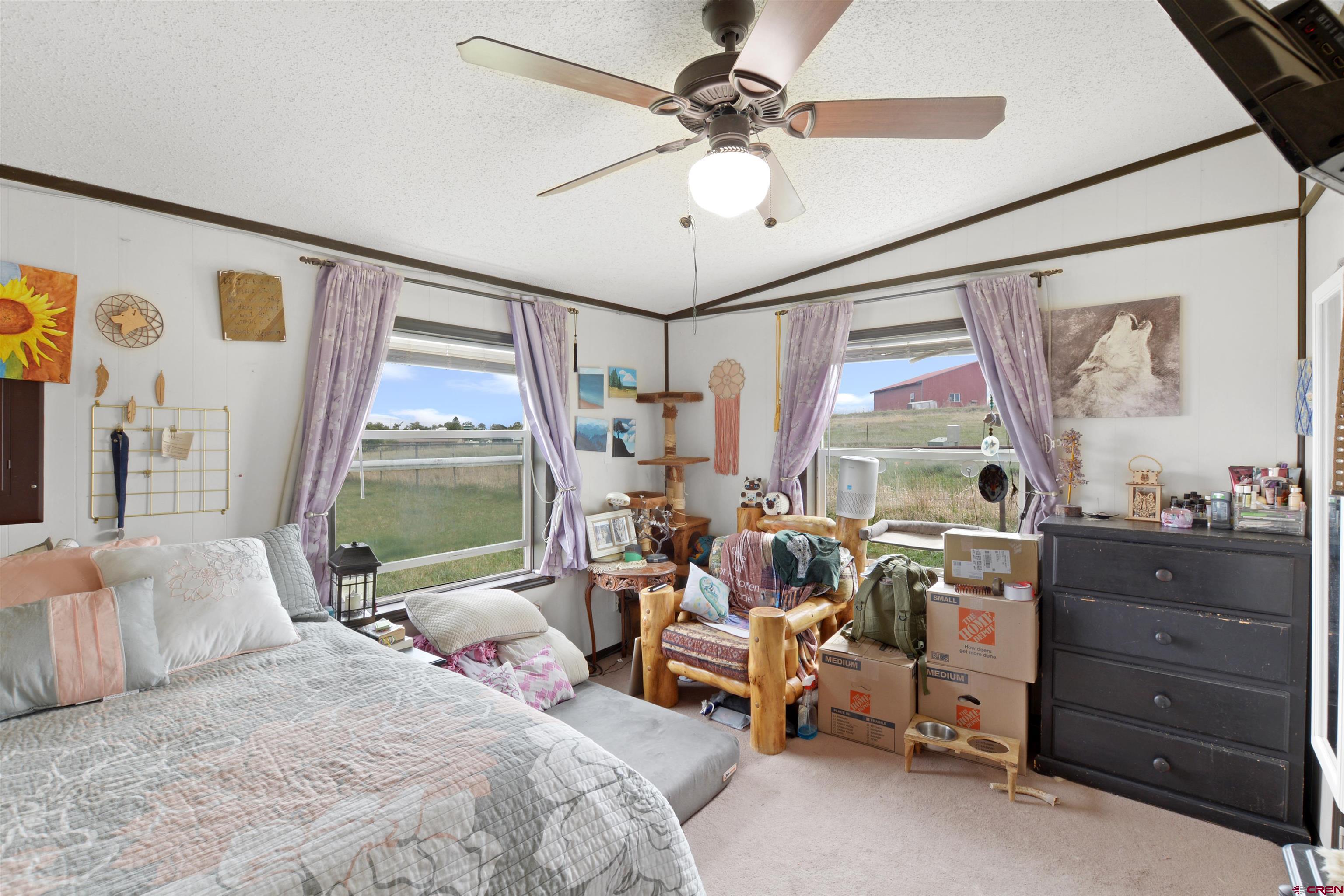3519 County Road 311 Ignacio, CO 81137 - Photo 13 of 22 a bedroom with a bed and a chandelier