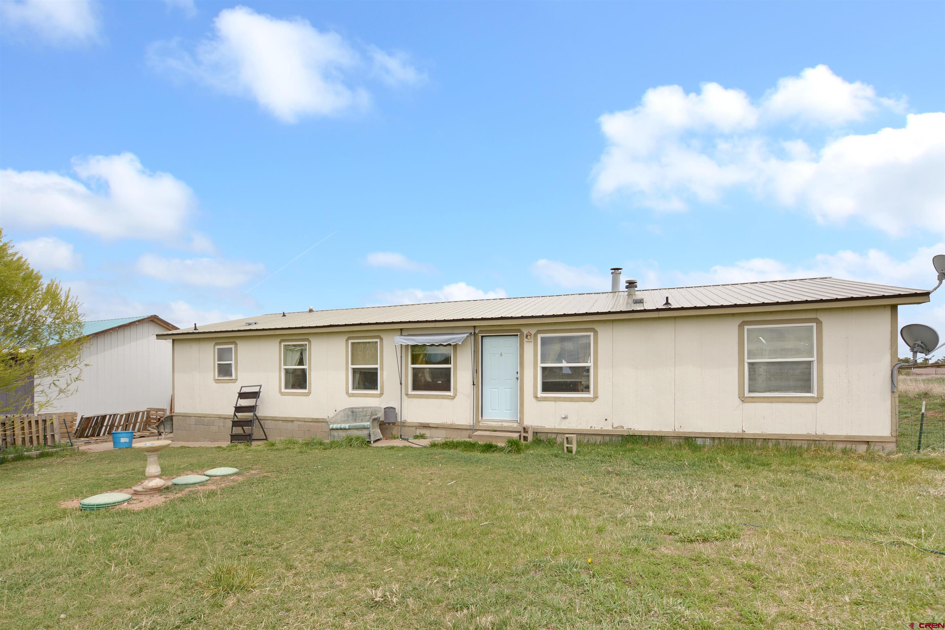 3519 County Road 311 Ignacio, CO 81137 - Photo 21 of 22 a front view of a house with a garden and yard
