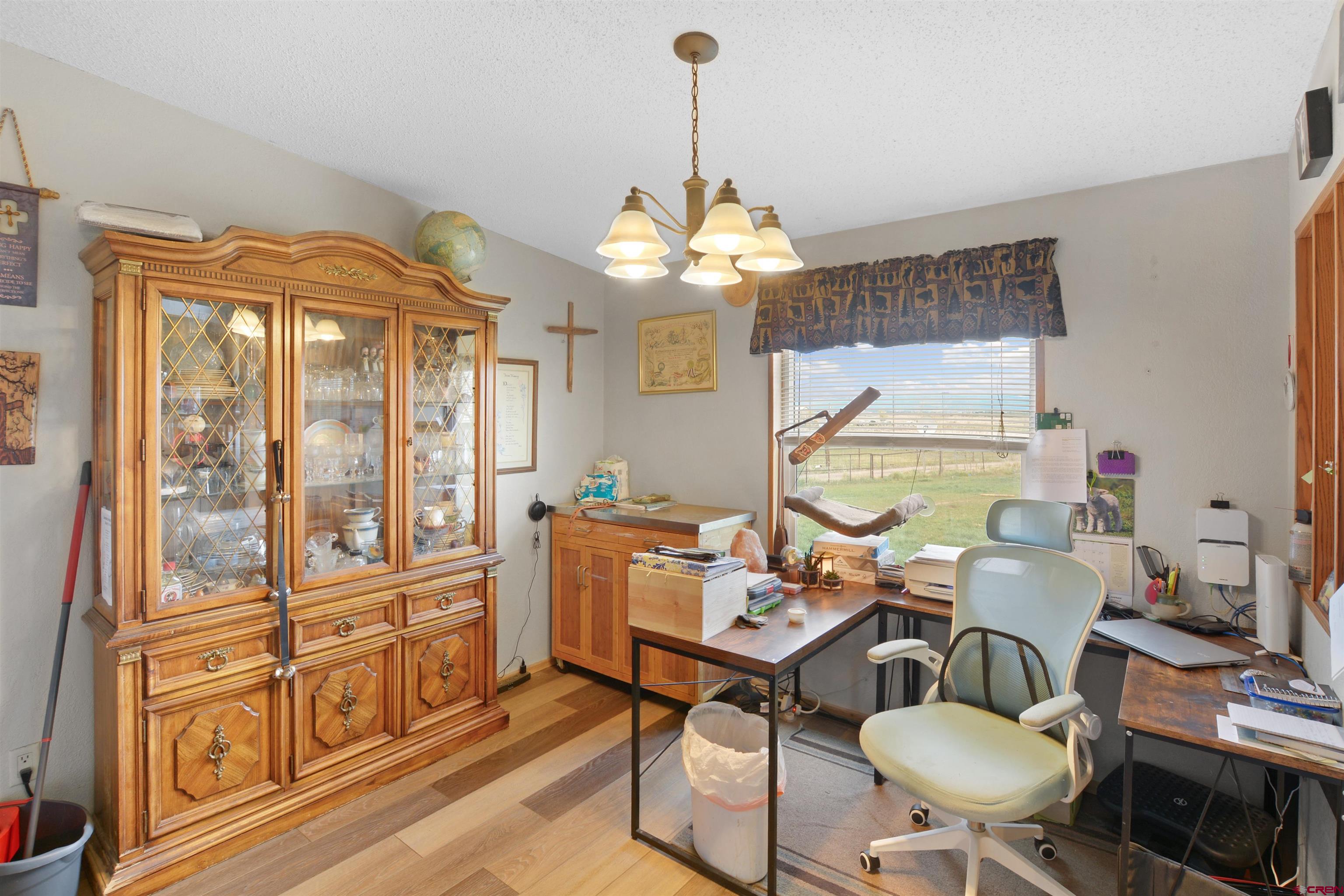 3519 County Road 311 Ignacio, CO 81137 - Photo 6 of 22 a room with chandelier fan and wooden floor