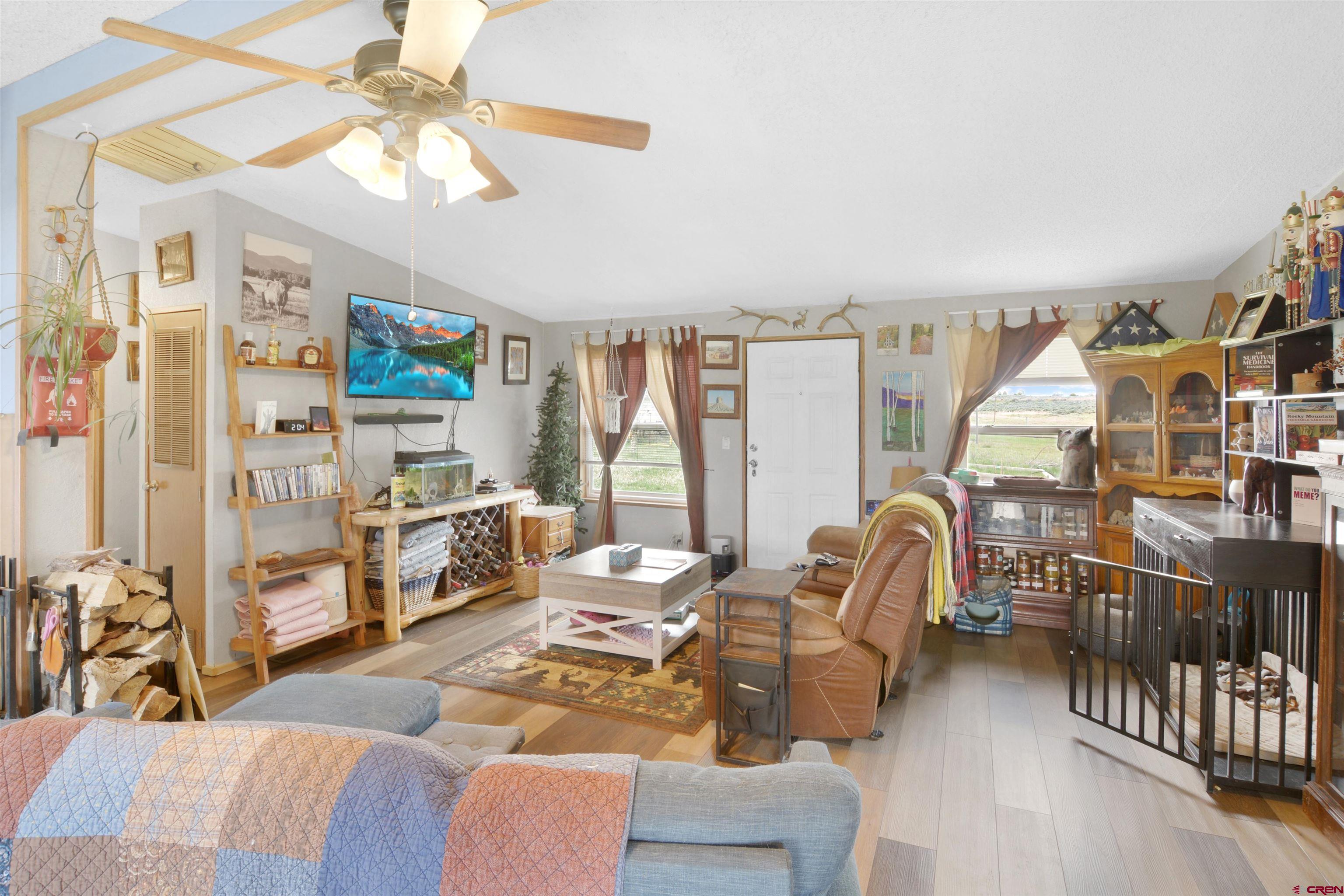 3519 County Road 311 Ignacio, CO 81137 - Photo 8 of 22 a living room with furniture a flat screen tv and a large window