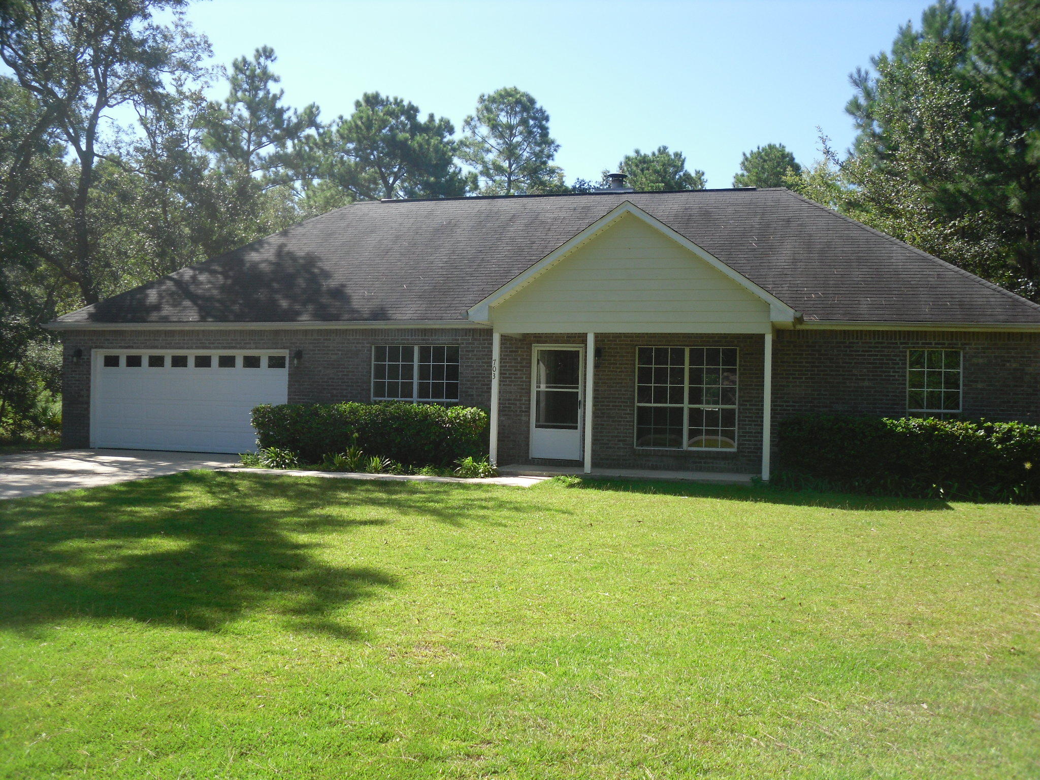 703 Bay Grove Road Freeport, FL 32439 - Photo 1 of 22 a front view of a house with a garden