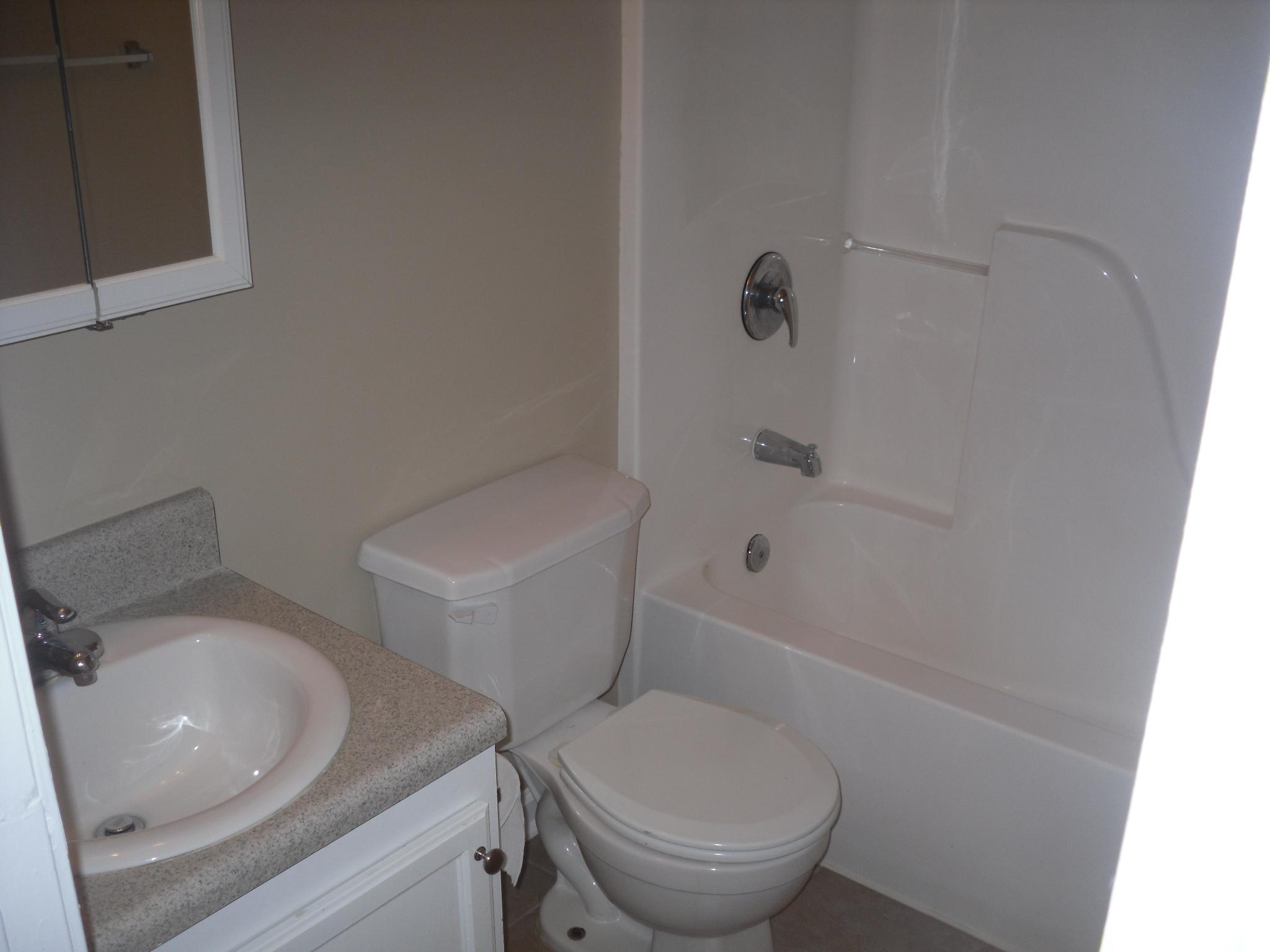 703 Bay Grove Road Freeport, FL 32439 - Photo 14 of 22 a white toilet sitting next to a bath tub