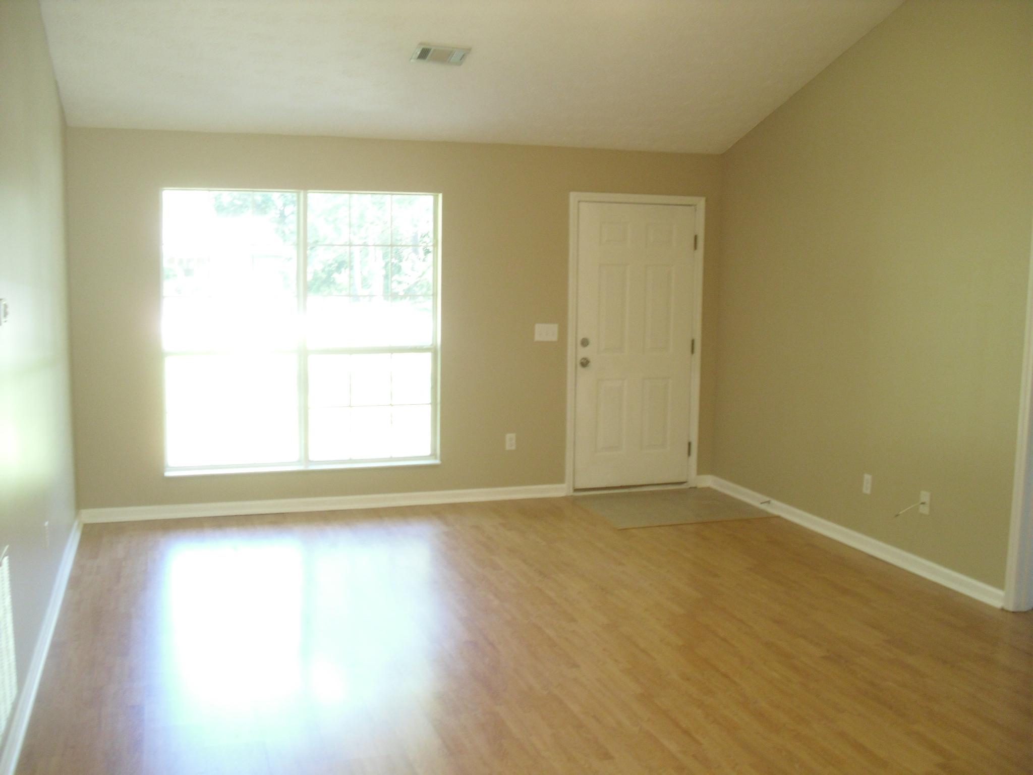 703 Bay Grove Road Freeport, FL 32439 - Photo 4 of 22 an empty room with wooden floor and windows