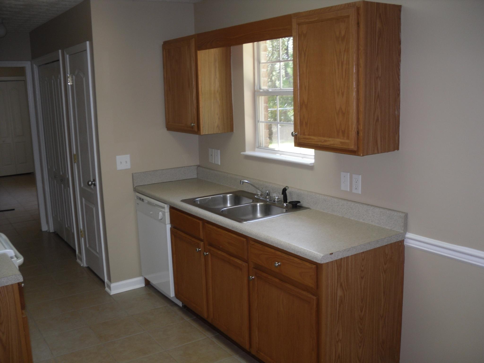 703 Bay Grove Road Freeport, FL 32439 - Photo 7 of 22 a kitchen with a sink cabinets and a window