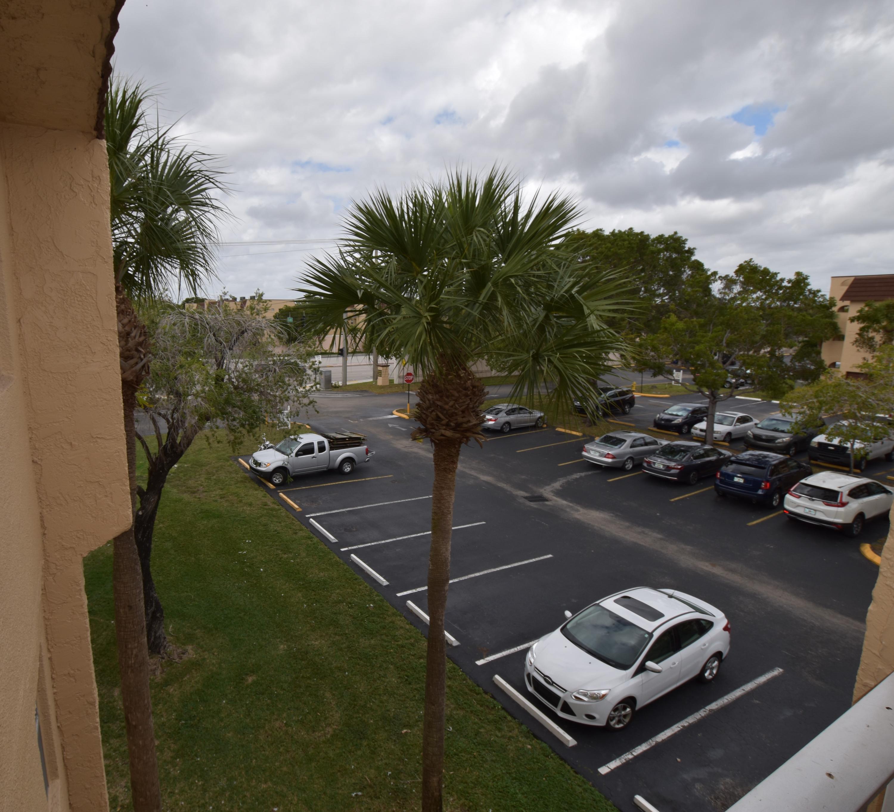 2780 North Pine Island Road, Unit 312 Sunrise, FL 33322 - Photo 14 of 30 a car parked on the side of the road