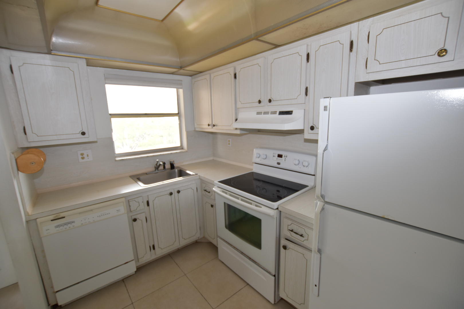 2780 North Pine Island Road, Unit 312 Sunrise, FL 33322 - Photo 3 of 30 a kitchen with white cabinets and white appliances