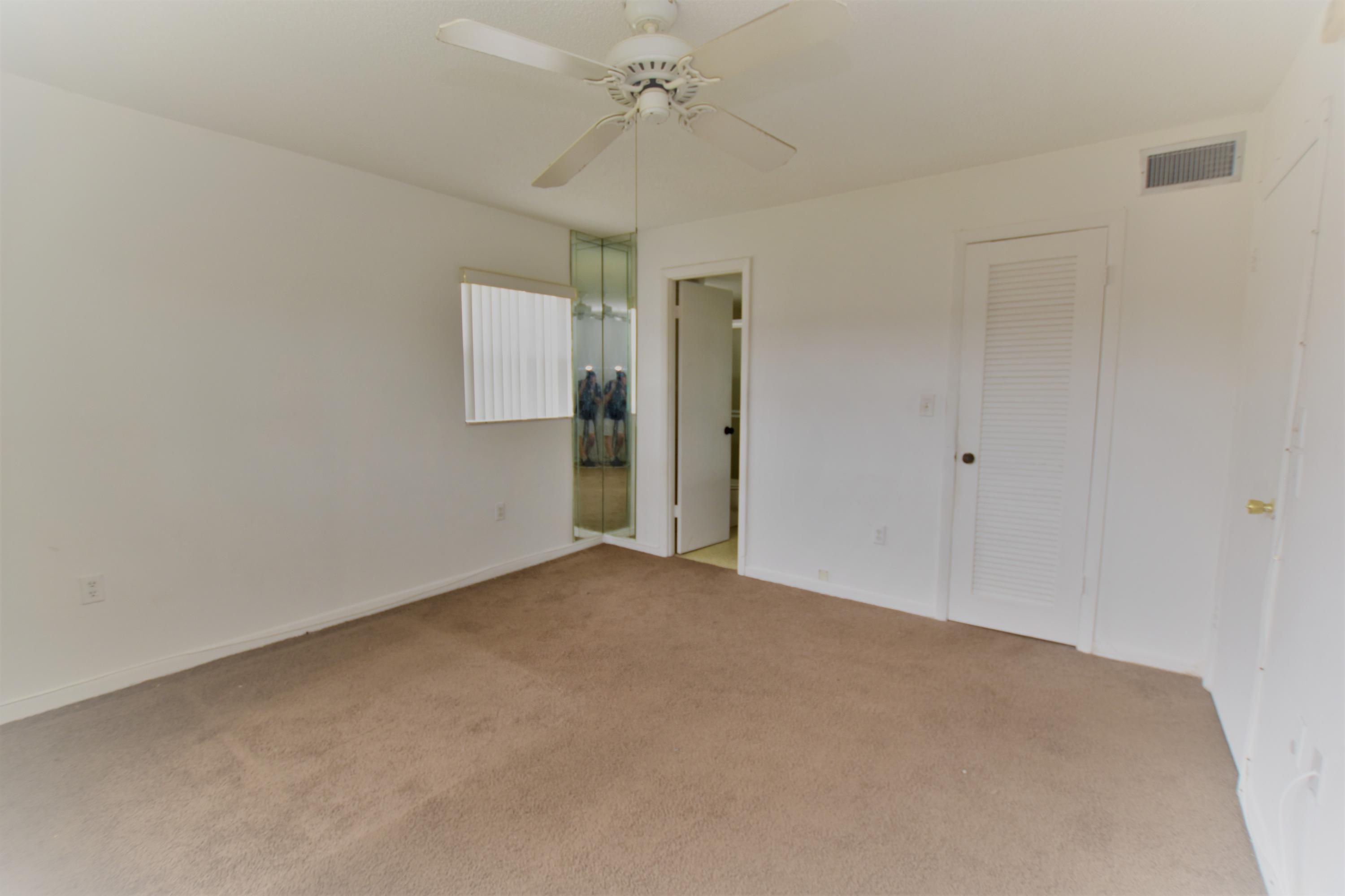 2780 North Pine Island Road, Unit 312 Sunrise, FL 33322 - Photo 7 of 30 a view of an empty room with a ceiling fan
