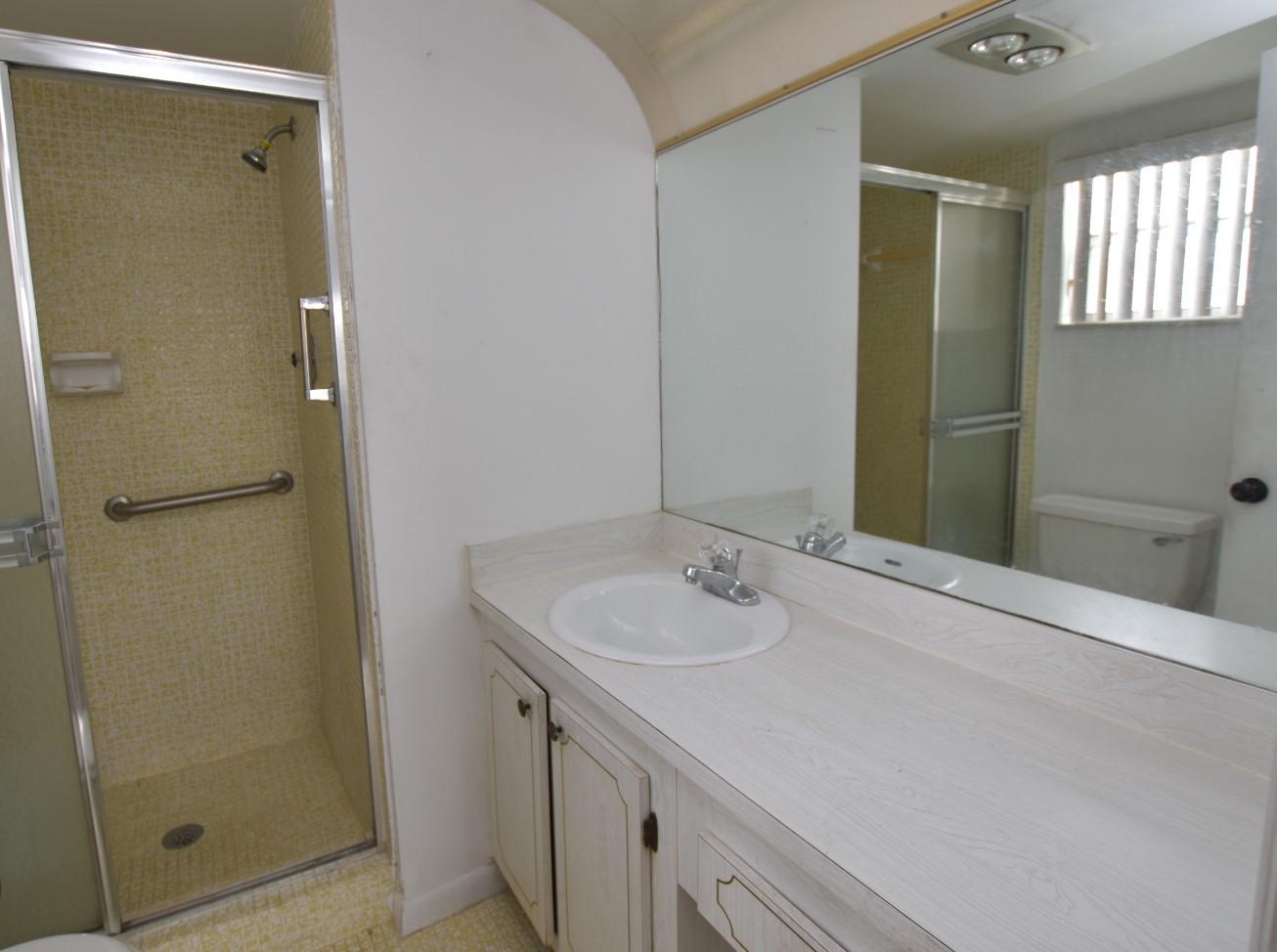 2780 North Pine Island Road, Unit 312 Sunrise, FL 33322 - Photo 8 of 30 a bathroom with a granite countertop sink shower and a mirror