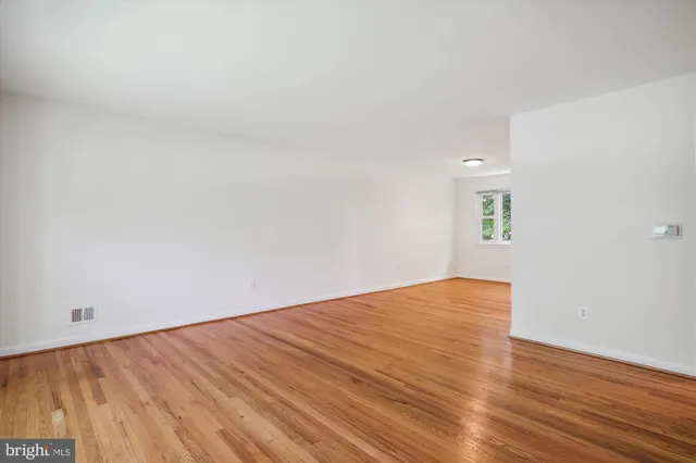 a view of an empty room and wooden floor