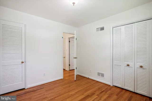an empty room with wooden floor