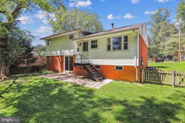 a view of a green field with trees