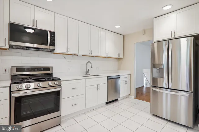 a kitchen with a refrigerator stove and microwave