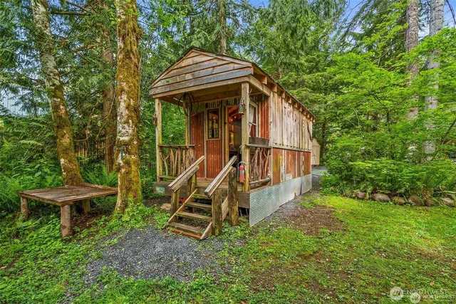 a view of a house with a wooden fence