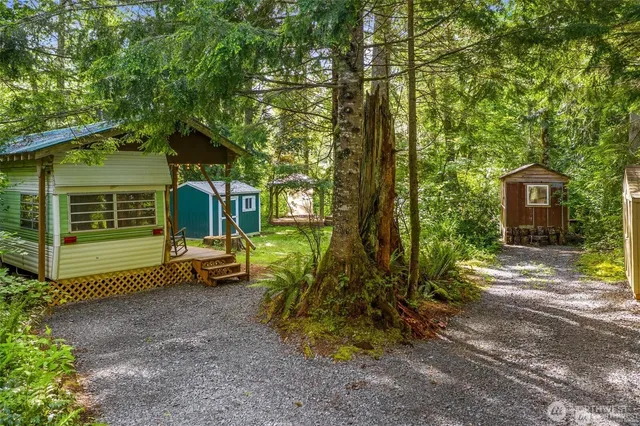 a view of a house with backyard and sitting area