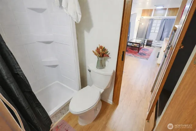 a white toilet sitting next to a bath tub