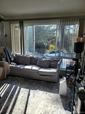 a living room with furniture and a large window