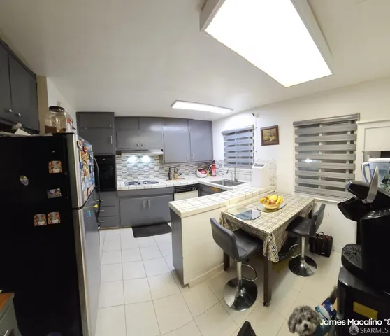 a kitchen with a sink cabinets and stainless steel appliances