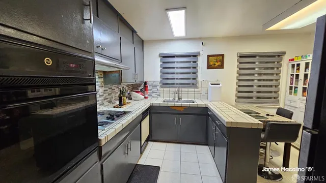 a living room with furniture a flat screen tv and a floor to ceiling window