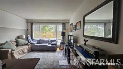 a view of a porch with furniture and floor to ceiling window