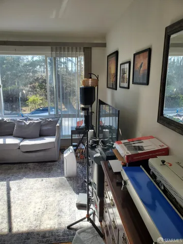 a living room with furniture and a floor to ceiling window
