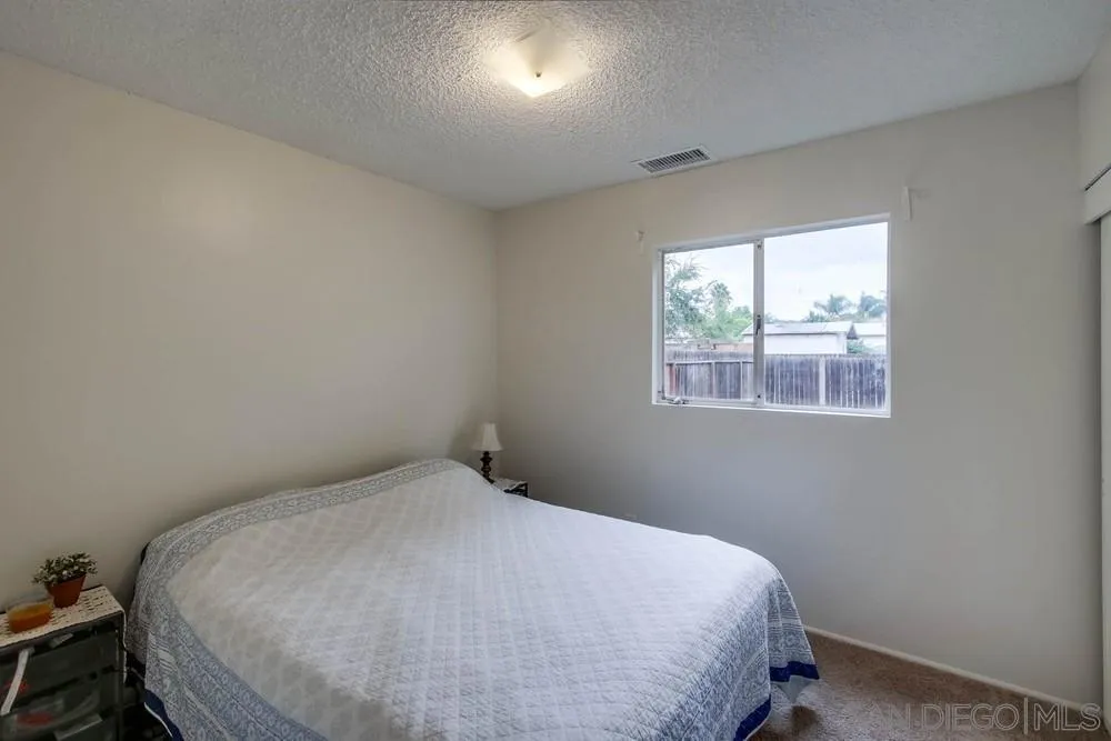 14574 Kennebunk Street Poway, CA 92064 - Photo 20 of 30 a bedroom with a bed and a window