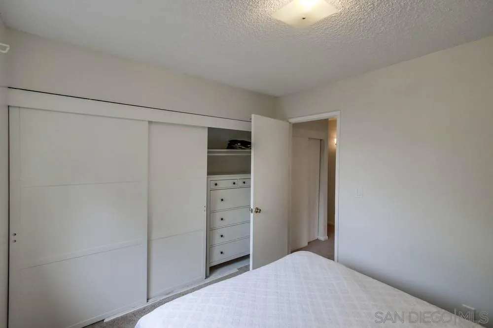 14574 Kennebunk Street Poway, CA 92064 - Photo 22 of 30 a bedroom with a closet and cabinet