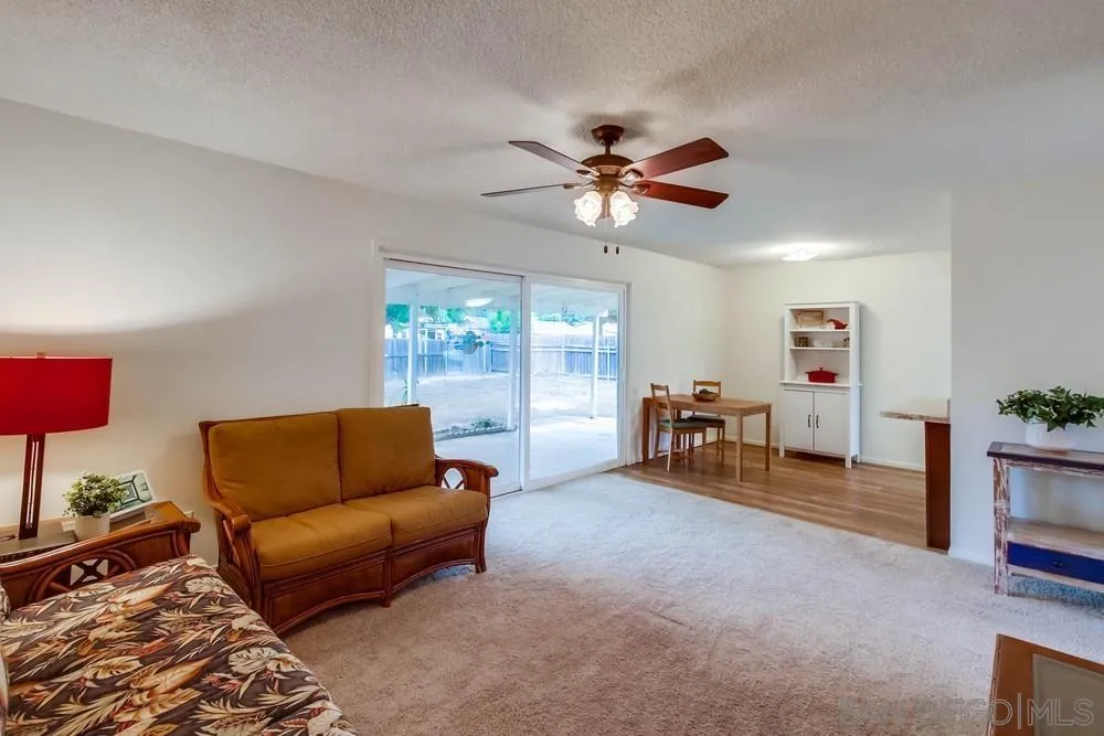 14574 Kennebunk Street Poway, CA 92064 - Photo 6 of 30 a living room with furniture and a flat screen tv