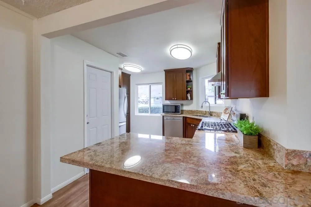 14574 Kennebunk Street Poway, CA 92064 - Photo 9 of 30 a kitchen with counter top space and cabinets