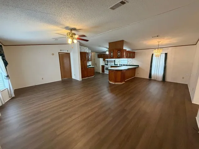 a view of a room with wooden floor