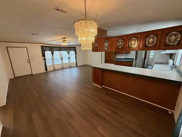 a view of a room with gym equipment and wooden floor