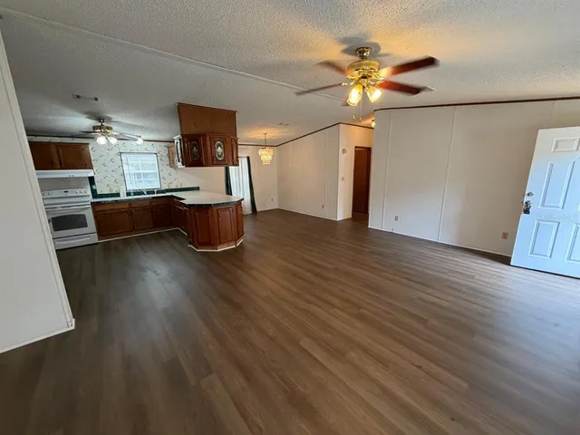 a view of kitchen with furniture and wooden floor