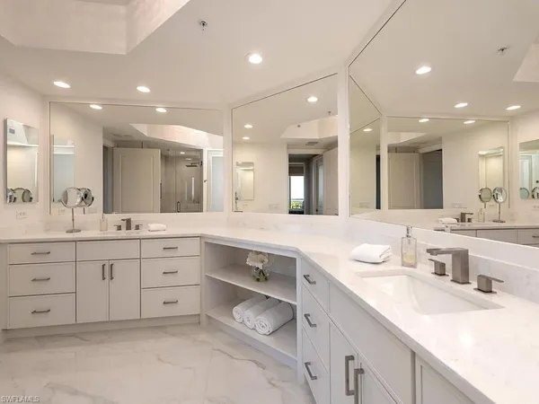 a bathroom with a double vanity sink mirror and shower