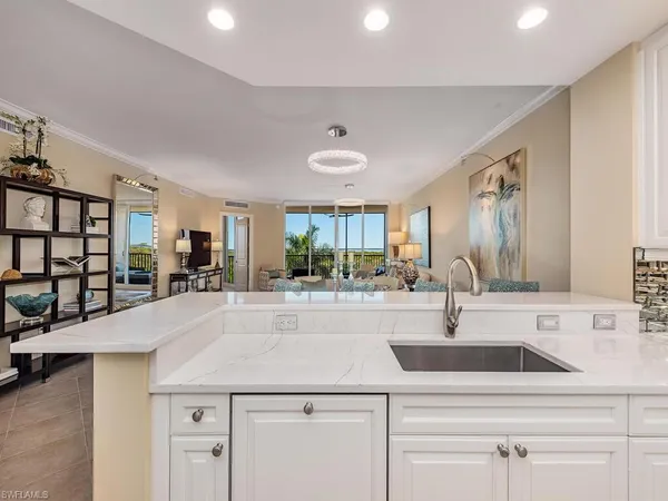 a view of kitchen island stainless steel appliances furniture stove microwave and refrigerator