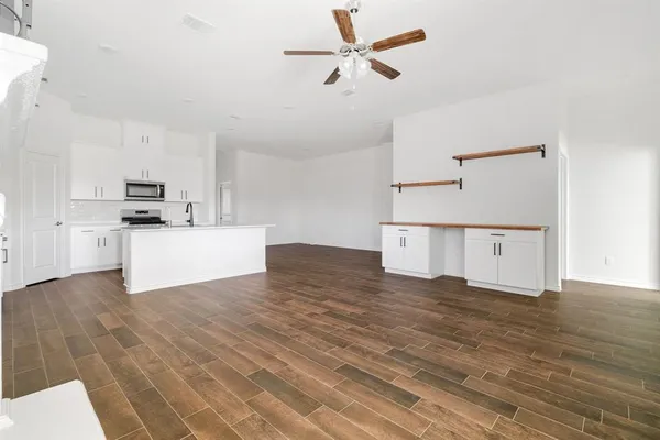a view of a kitchen with a sink and a refrigerator