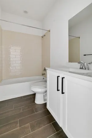 a bathroom with a sink a toilet and a shower