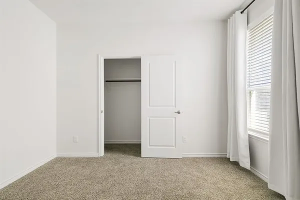 a view of an empty room and a window