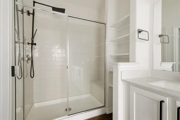 a bathroom with a shower and a sink