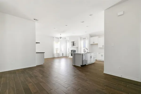 a view of kitchen and hall with wooden floor